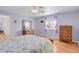 Calming bedroom featuring a large window, two dressers, and a bed at 3596 Longs Peak Cir, Parker, CO 80138