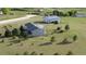 Scenic aerial view of single-story home and detached barn on a sprawling green lot at 3596 Longs Peak Cir, Parker, CO 80138