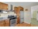 Cozy kitchen features stainless steel appliances, wood cabinets and tile backsplash at 3596 Longs Peak Cir, Parker, CO 80138