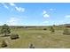 Expansive land with rolling hills, scattered trees, and panoramic views under a clear blue sky at 3596 Longs Peak Cir, Parker, CO 80138