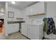 Laundry room features white cabinetry, a sink, and a washer and dryer set at 3596 Longs Peak Cir, Parker, CO 80138