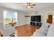 Comfortable living room featuring large windows and hardwood flooring at 3596 Longs Peak Cir, Parker, CO 80138