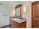 Bathroom showcasing a vanity with granite countertop, framed mirror, and sconce lighting at 14030 E Progress Way, Aurora, CO 80015