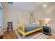 Bedroom features a wood floor, window, closet, and a yellow bedframe at 14030 E Progress Way, Aurora, CO 80015