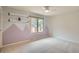 This bedroom features carpeted floors, a window, shelving, and an accent wall at 14030 E Progress Way, Aurora, CO 80015