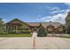 Charming home with brick accents, a manicured lawn, and a welcoming entrance, showcasing curb appeal at 14030 E Progress Way, Aurora, CO 80015