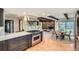 Modern kitchen with stainless steel appliances, a center island, and an open layout to the dining and Gathering room at 14030 E Progress Way, Aurora, CO 80015