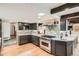 Stylish kitchen featuring granite countertops, stainless steel appliances, and ample storage, perfect for cooking at 14030 E Progress Way, Aurora, CO 80015