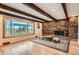 Inviting living room with a stone fireplace, large windows, and hardwood floors, creating a cozy atmosphere at 14030 E Progress Way, Aurora, CO 80015
