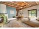 View of the primary bedroom with stylish décor and a wood-beamed ceiling at 14030 E Progress Way, Aurora, CO 80015