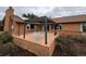 Brick patio featuring a modern pergola with comfortable seating, and established landscaping at 14030 E Progress Way, Aurora, CO 80015