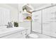 Bright bathroom featuring a white vanity, floating shelves with decor, and a glass-enclosed shower at 1629 N Clarkson St # 23, Denver, CO 80218