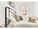 Bright bedroom with large windows, decorative pillows, and comfortable bedding at 1629 N Clarkson St # 23, Denver, CO 80218