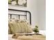 Comfortable bedroom setting with decorative pillows, and a cozy tray with small planter and mugs at 1629 N Clarkson St # 23, Denver, CO 80218