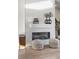 Cozy living room with tiled fireplace, modern accents, and stylish poufs at 10866 Lyric St, Lone Tree, CO 80134
