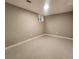 Neutral basement area with a window and neutral-colored carpet at 9017 E Oxford Dr, Denver, CO 80237