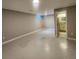 Spacious basement with concrete flooring, neutral walls, and a bathroom entrance at 9017 E Oxford Dr, Denver, CO 80237