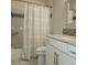 Bathroom featuring a shower/tub combo with white subway tile and a patterned shower curtain at 9017 E Oxford Dr, Denver, CO 80237