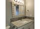 Bright bathroom with a stylish mirror, vanity, and sleek fixtures at 9017 E Oxford Dr, Denver, CO 80237