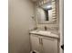 Stylish powder room with granite countertop, modern mirror, and neutral paint at 9017 E Oxford Dr, Denver, CO 80237