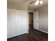 Bedroom with wood floors, closet, and doorway to another room at 9017 E Oxford Dr, Denver, CO 80237