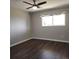 Cozy bedroom featuring a ceiling fan and a large window that brings in natural light at 9017 E Oxford Dr, Denver, CO 80237