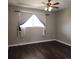 Spacious bedroom with a ceiling fan and a large window that brings in natural light at 9017 E Oxford Dr, Denver, CO 80237