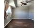 Spacious bedroom featuring a ceiling fan, neutral paint, and large window at 9017 E Oxford Dr, Denver, CO 80237