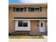 Traditional brick townhome with black shutters and a well-manicured front lawn at 9017 E Oxford Dr, Denver, CO 80237