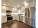 Updated kitchen features stainless steel appliances, granite counters and white cabinets at 9017 E Oxford Dr, Denver, CO 80237