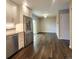 Modern kitchen flowing into a dining space, complete with stainless steel appliances at 9017 E Oxford Dr, Denver, CO 80237