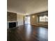 Inviting living room boasts a stone fireplace, wood floors, and a bright window seat at 9017 E Oxford Dr, Denver, CO 80237