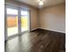 Bright living room features wood floors and sliding glass doors to a private fenced outdoor space at 9017 E Oxford Dr, Denver, CO 80237