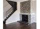 Close-up of the living room's fireplace with stone surround and wood floors at 9017 E Oxford Dr, Denver, CO 80237