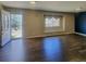 Bright living room featuring wood floors, a cozy window seat, and ample natural light at 9017 E Oxford Dr, Denver, CO 80237