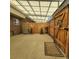 Covered patio area with wooden fencing, a pea gravel floor, and a view of the house at 9017 E Oxford Dr, Denver, CO 80237