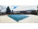Community pool with a secured cover and surrounded by well-maintained residential buildings at 9017 E Oxford Dr, Denver, CO 80237