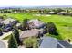 Stunning aerial view of a home overlooking a lush golf course and rolling hills, a picturesque setting at 1287 Buffalo Ridge Rd, Castle Pines, CO 80108