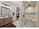 Elegant bathroom with a modern walk-in shower, dual shower heads, and a stylish vanity with generous storage at 1287 Buffalo Ridge Rd, Castle Pines, CO 80108