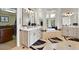 Bathroom with dual vanities, framed mirrors, and a soaking tub with a beautiful bay window at 1287 Buffalo Ridge Rd, Castle Pines, CO 80108