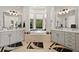Bright bathroom with dual vanities, large mirrors, and a soaking tub set in a bay window at 1287 Buffalo Ridge Rd, Castle Pines, CO 80108