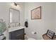Bathroom with a modern vanity, framed mirror, and stylish fixtures with a painting on the wall at 1287 Buffalo Ridge Rd, Castle Pines, CO 80108