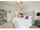 Bedroom features a ceiling fan, a gray upholstered headboard, and a shelf with plants and decor at 1287 Buffalo Ridge Rd, Castle Pines, CO 80108