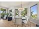 Bright dining area features a modern chandelier, large windows and a view to a vibrant greenbelt at 1287 Buffalo Ridge Rd, Castle Pines, CO 80108