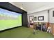 Indoor golf simulator room offering a unique recreational space for practicing and enjoying the sport at home at 1287 Buffalo Ridge Rd, Castle Pines, CO 80108