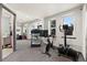 Bright home gym filled with natural light, featuring modern exercise equipment and a mirrored wall for optimal fitness at 1287 Buffalo Ridge Rd, Castle Pines, CO 80108