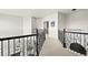 Bright hallway with wrought iron railing and view of the interior design elements throughout the home at 1287 Buffalo Ridge Rd, Castle Pines, CO 80108