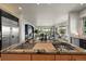 A gourmet kitchen featuring a large island with double sinks and stone countertops at 1287 Buffalo Ridge Rd, Castle Pines, CO 80108