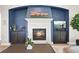 Comfortable living room with an elegant fireplace, custom cabinets, and stylish decor at 1287 Buffalo Ridge Rd, Castle Pines, CO 80108