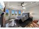 Luxury main bedroom featuring tray ceilings, large windows, and a comfortable sitting area at 1287 Buffalo Ridge Rd, Castle Pines, CO 80108